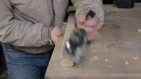 Carpenter work with plane on wood plank Stock Footage 73169945