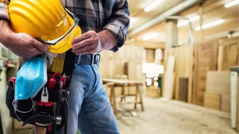 Carpenter with work tools and surgical mask on white background. Carpentry. C Stock Photos