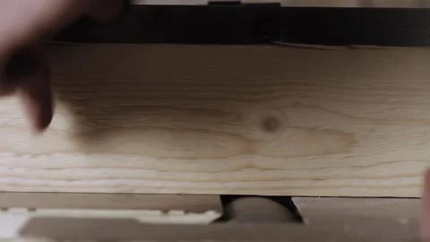 Carpenter work with wood joiner planer. male worker hands processing wood usi Stock Footage 166337114