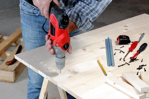 Carpenter at work on the wood. Stock Photos