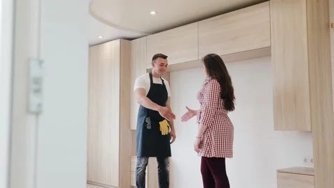 Carpenter worker is communicate with customer and shows his work with furniture Stock Footage 130452478