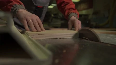Carpenter, worker cuts a wooden board with a circular saw on a workbench Stock Footage 149308764