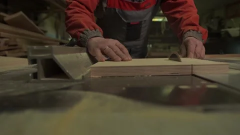 Carpenter, worker cuts a wooden board with a circular saw on a workbench Stock Footage 149309087