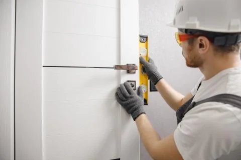 Carpenter worker installation process of wood door hinge Stock-Fotos