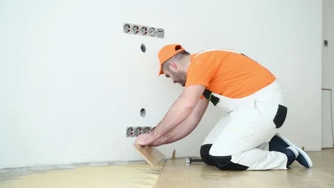 Carpenter worker joining parket floor Stock Footage 85070959