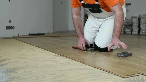 Carpenter worker joining parket floor. slow motion Stock Footage 85071741