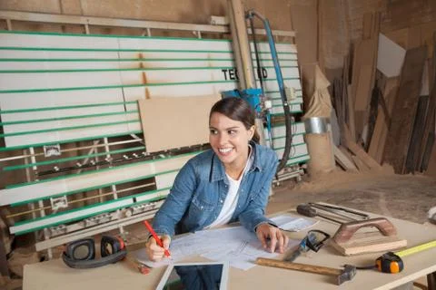 Carpenter Working On Blueprint While Looking Away Stock Photos