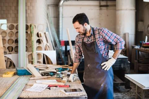 Carpenter working carefully looking at the plans Stock Photos
