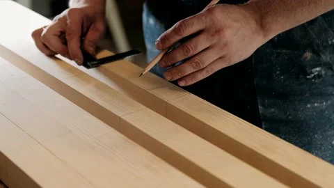 Carpenter working in the carpentry workshop. Worker takes measurements. Stock Footage 140675060