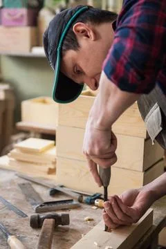 Carpenter working with a chisel Carpenter working with a chisel and hammer... Stock Photos