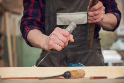 Carpenter working with a chisel Stock Photos