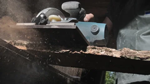 Carpenter working with circular saw. Cutting off a piece of wood in slow motion Stock Footage 205942298