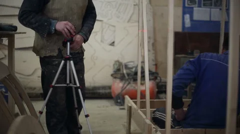 Carpenter working with a construction laser level Stock Footage 59560030