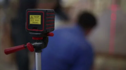 Carpenter working with a construction laser level Stock Footage 59560634