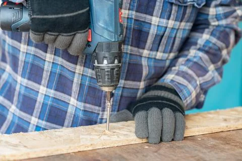 Carpenter working with an cordless screwdriver. Stock Photos