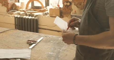 Carpenter working on a drawing, close-up, in a carpentry workshop Video stock 74715335
