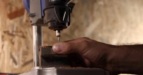 Carpenter working on the drill machine in his workshop Video stock 233581923