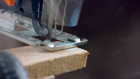 Carpenter working electric jigsaw, closeup, detail. Sawdust fly. Stock Footage 161347532