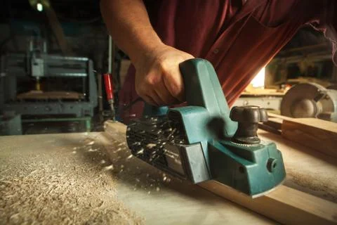 Carpenter working with electric planer. Stock-Fotos