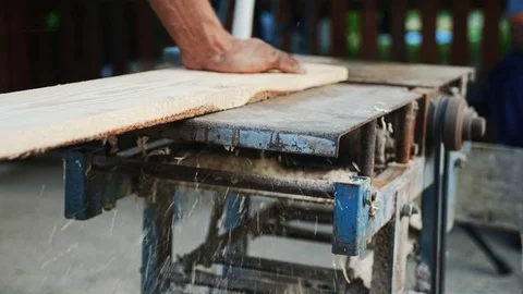 Carpenter working with electric planer on plank Stock Footage 78879063