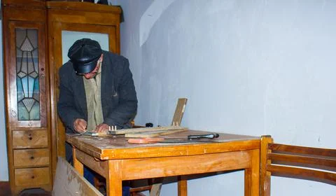 Carpenter working on the floor, old man in kitchen Stockfoto's