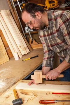 Carpenter working with a hammer, chisel and wood carving tools. Foto stock