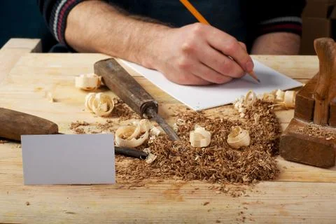 Carpenter working, hammer, meter and screw-driver on construction background. Stock Photos