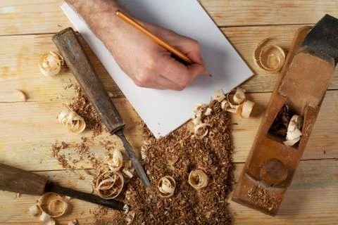 Carpenter working, hammer, meter and screw-driver on construction background. Stock Photos