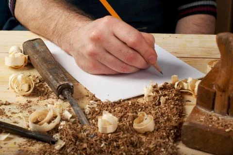 Carpenter working, hammer, meter and screw-driver on construction background. Stock Photos