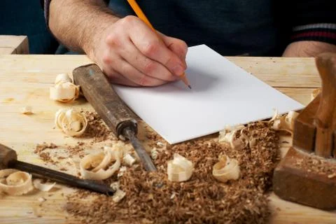 Carpenter working, hammer, meter and screw-driver on construction background. Stock Photos