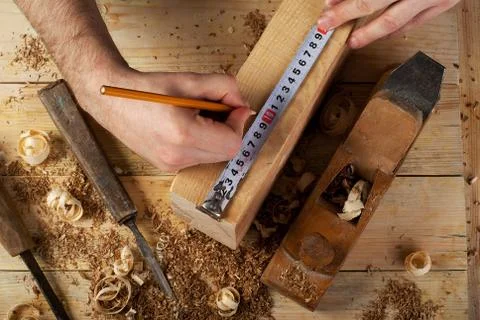 Carpenter working, hammer, meter and screw-driver on construction background. Stock Photos