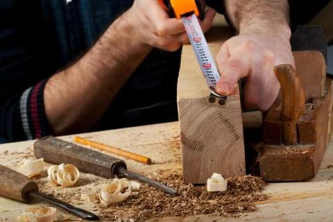 Carpenter working, hammer, meter and screw-driver on construction background. Foto stock