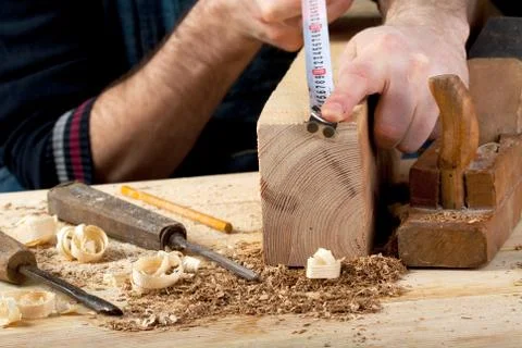 Carpenter working, hammer, meter and screw-driver on construction background Stock Photos