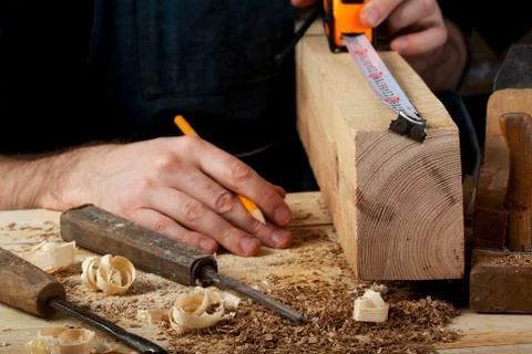 Carpenter working, hammer, meter and screw-driver on construction background. Stock Photos