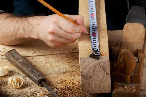 Carpenter working, hammer, meter and screw-driver on construction background. Foto stock