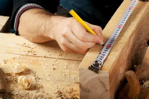 Carpenter working, hammer, meter and screw-driver on construction background. Stock Photos