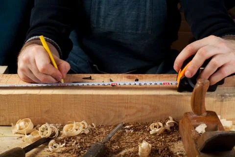 Carpenter working, hammer, meter and screw-driver on construction background. Foto stock