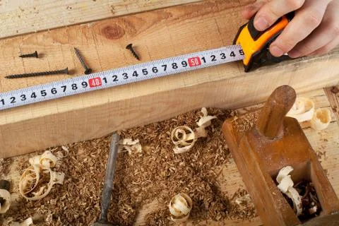 Carpenter working, hammer, meter and screw-driver on construction background Stock Photos
