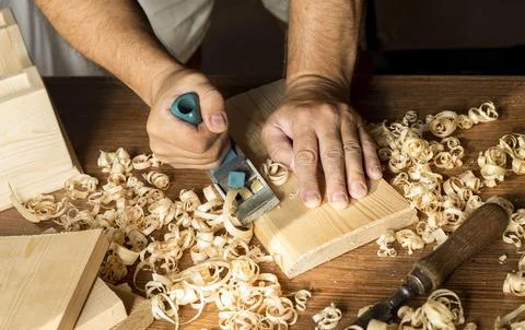 Carpenter working with his bare hands wood High resolution photo Stock Photos