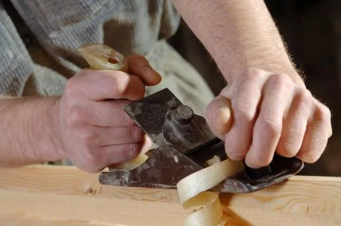 Carpenter working with a planer in his workshop Foto stock