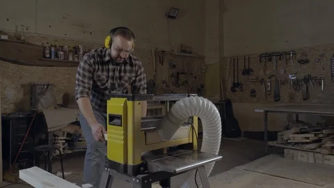 Carpenter working on professional planer machine in carpentry workshop Stock Footage 101948724