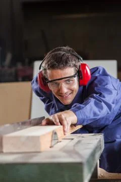 Carpenter working with a saw Stock Photos