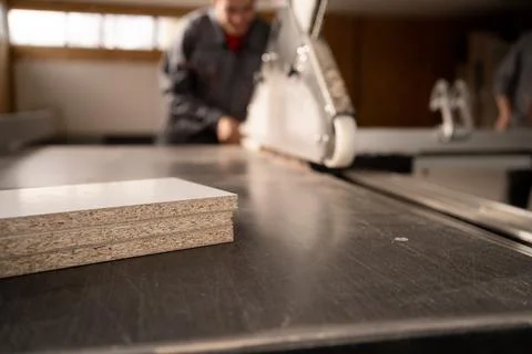 Carpenter working with sliding panel saw and sawing mdf board or fibreboard.. Stock Photos