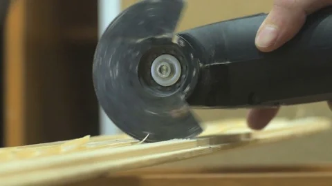 Carpenter working with wood using grinder multi tool. 4k close up Video stock 77624587