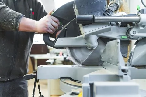 Carpenter working on wood by using a grinding machine, workshop Stock Photos