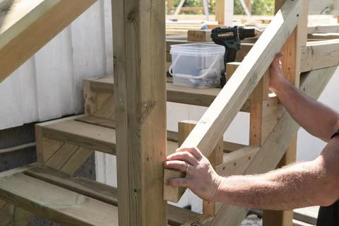 Carpenter working on woodworking construction Stock Photos