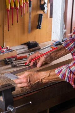 Carpenter working on the work bench, joinery tools and woodwork Stock Photos