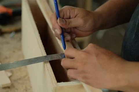 Carpenter working in workshop. carpenter measuring using pencil and ruler. Stock Photos