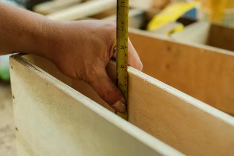 Carpenter working in workshop. carpenter measuring using pencil and ruler. Stock Photos