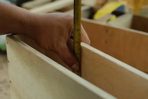 Carpenter working in workshop. carpenter measuring using pencil and ruler. Stock Photos